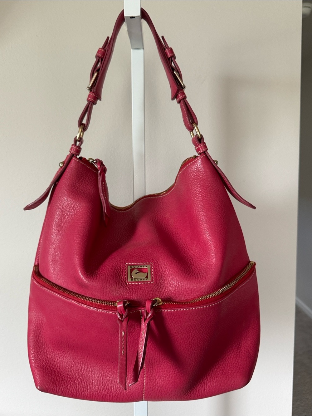 Dooney & Bourke Dillen pebbled leather hobo bag in a vibrant pink